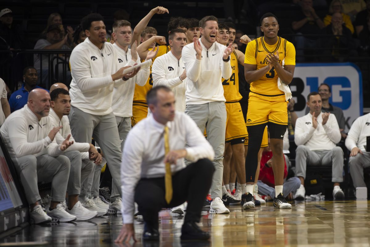 The Iowa bench cheers during a basketball game between the Iowa Hawkeyes and the Southeast Missouri State Redhawks at Carver-Hawkeye Arena on Thursday, Nov. 18, 2025. The Hawkeyes defeated the Redhawks 99-70.
