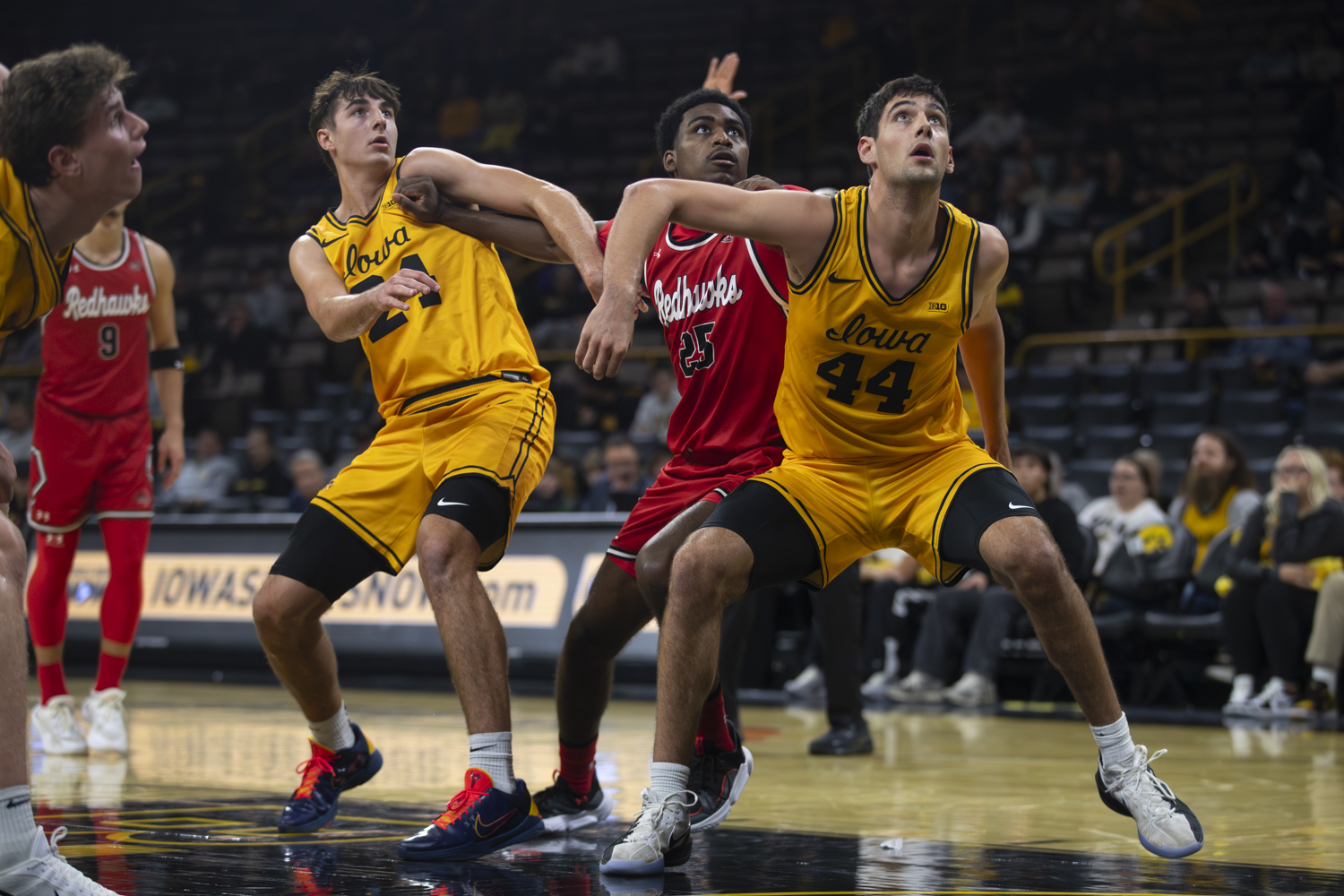 Iowa guard Tate Sage and forward Joey Matteoni attempt to box out Southeast Missouri guard Jay Reynolds during a basketball game between the Iowa Hawkeyes and the Southeast Missouri State Redhawks at Carver-Hawkeye Arena on Thursday, Nov. 18, 2025. Sage added seven points. The Hawkeyes defeated the Redhawks 99-70.