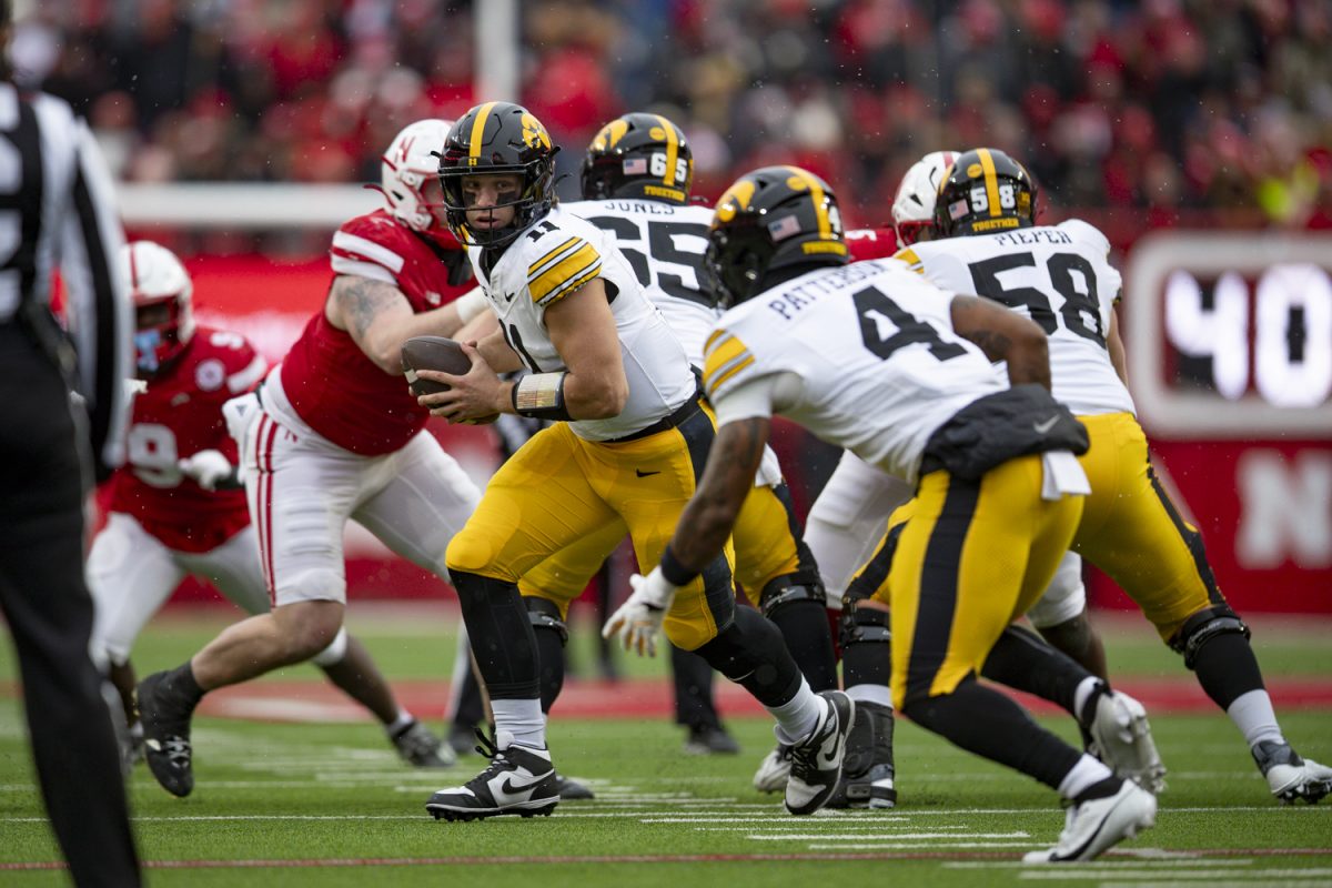 Iowa quarterback Mark Gronowski looks for a pass during a football game between Iowa and Nebraska at Memorial Stadium in Lincoln, Nebraska on Friday, Nov. 28, 2025. The Hawkeyes defeated the Cornhuskers 40-16.