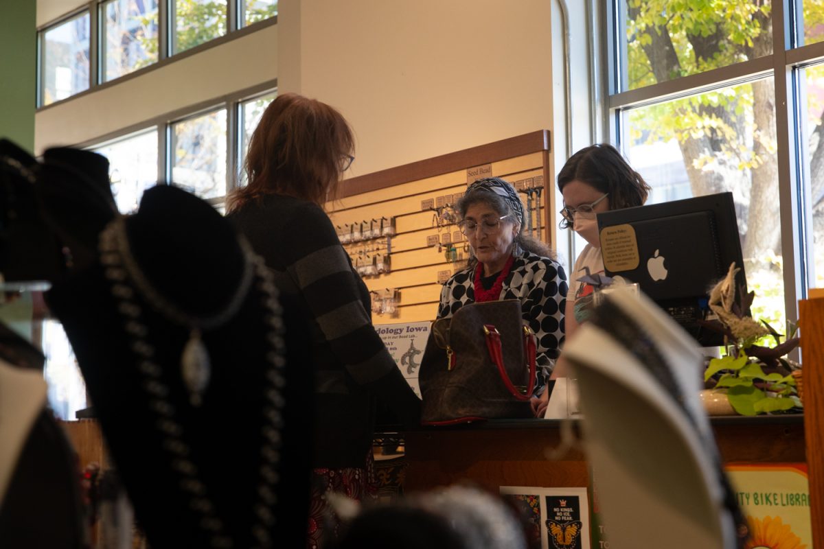 Karen Kubby,  co-owner of Beadology and new ICDD member, and Emma Folsom, 2-year employee, give tips to customer Michelle Bennet about constructing her own necklace at Beadology in Iowa City, Iowa, on Nov. 3, 2025. The store carries handmade jewelry, tools, beadwork supplies, and offers many classes in jewelry making.