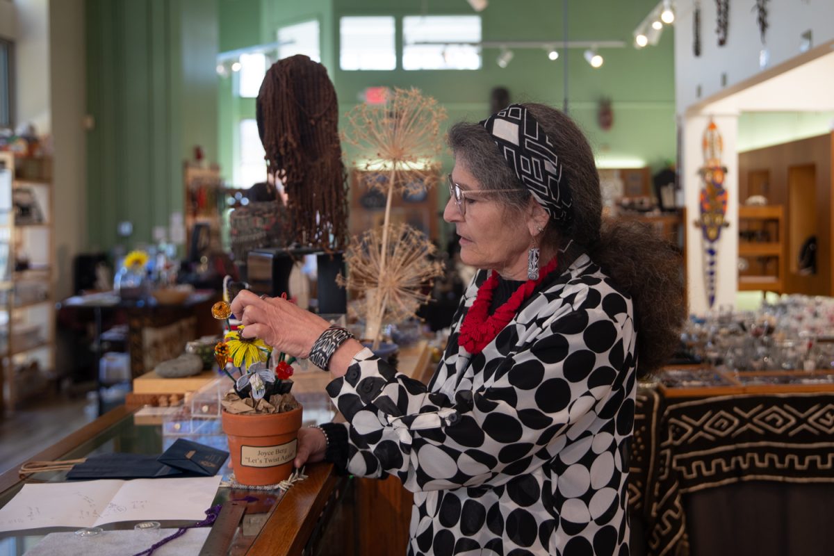 Karen Kubby, co-owner of Beadology and new ICDD member, adjusts the petals of a beaded bouquet at Beadology in Iowa City, Iowa, on Nov. 3, 2025. A customer handmade the bouquet after taking a class at Beadology and gifted it to be momentarily displayed in the store.
