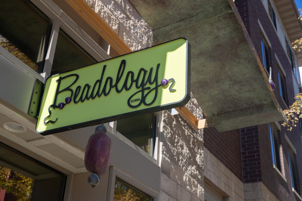 A large decorative dangles from a Beadology sign at Beadology in Iowa City, Iowa, on Nov. 3, 2025. Beadology was purchased by Laurel and Karen Kubby in August of 2008.
