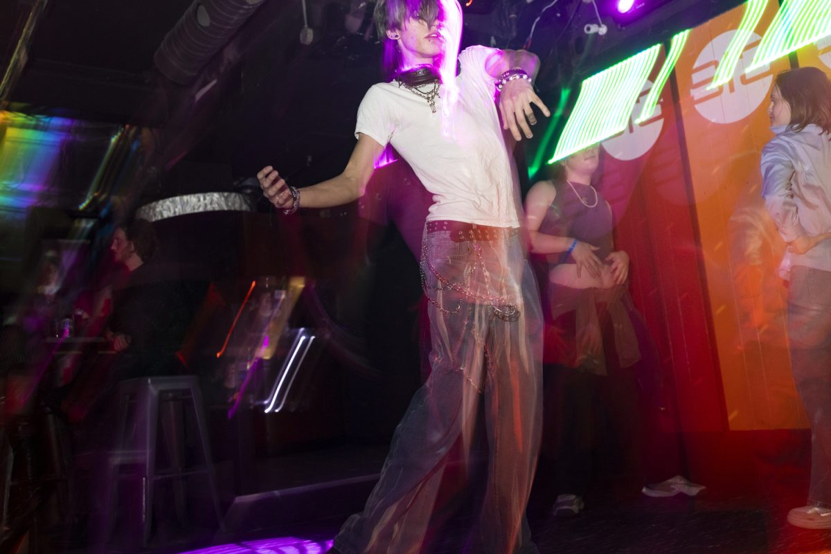 A bargoer dances at Studio 13 in Iowa City on Friday, Dec. 5, 2025. Studio 13 hosts drag shows opens up their dance floor six days a week and is known as the primary LGBTQ+ bar in the Iowa City area. (Emma Calabro/The Daily Iowan)