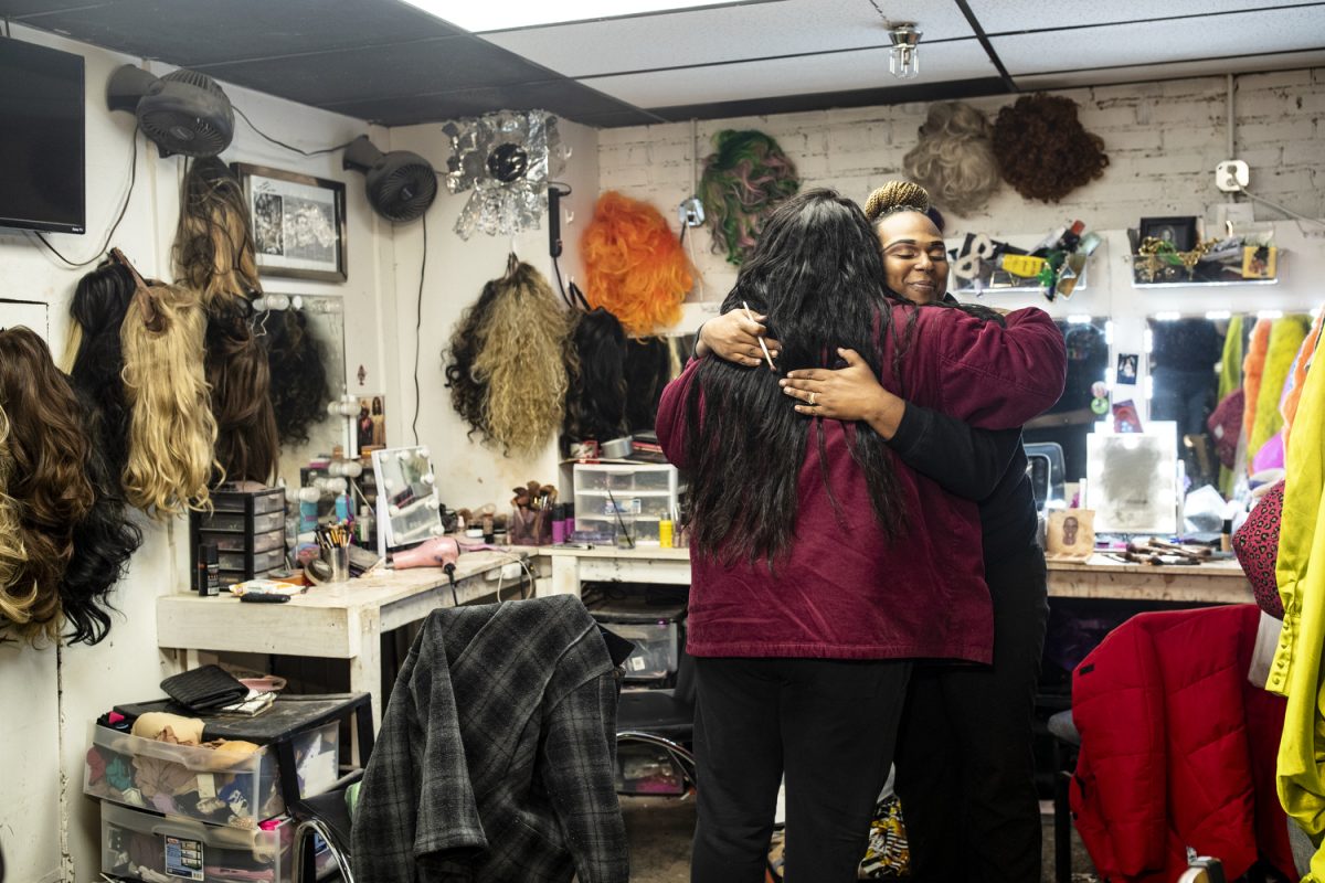 Drag queen Paris Taylor hugs Iiman Trinidad at Studio 13 in Iowa City on Friday, Dec. 5, 2025. Taylor produced the show TRANTASY which highlights trans and non-binary performers.