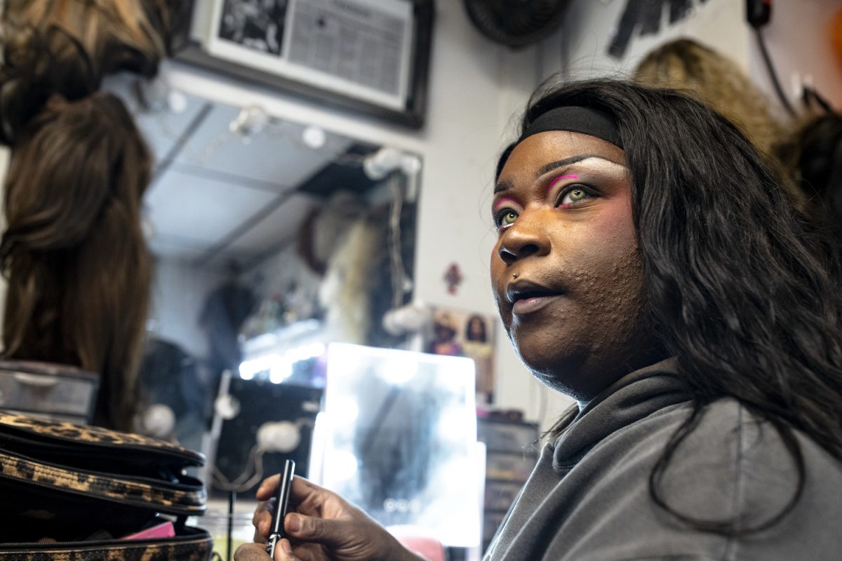 Iiman Trinidad listens to another performer while getting ready for a show at Studio 13 in Iowa City on Friday, Dec. 5, 2025. Studio 13 offers four drag shows a week with different local drag performers. (Emma Calabro/The Daily Iowan)