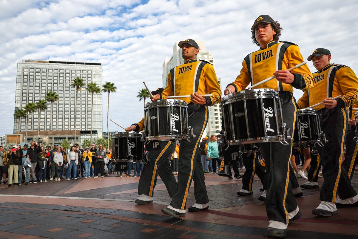 The Hawkeye Marching Band exits after performing during a Hawkeye Huddle at the Tampa Convention Center Outdoor Plaza on Tuesday, Dec. 30, 2025. The huddle included Iowa Spirit Squads, the Hawkeye Marching Band, and special guests ahead of a matchup between the Iowa Hawkeyes and the Vanderbilt Commodores on Wednesday, Dec. 31. (Emma Calabro/The Daily Iowan)