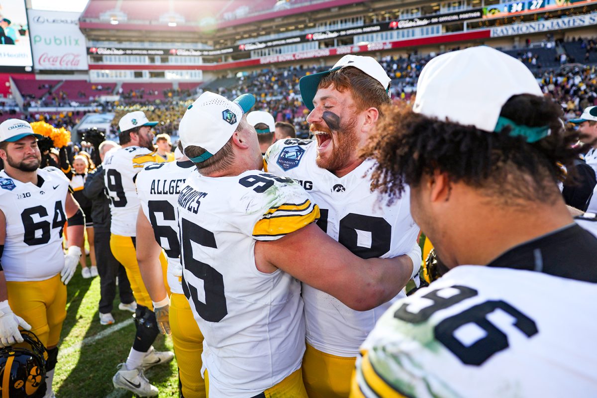 Iowa defensive lineman Aaron Graves  and Iowa defensive lineman Max Llewellyn celebrate after winning a football game between Iowa and No. 14 Vanderbilt at Raymond James Stadium in Tampa, Florida on Wednesday, Dec. 31, 2025. The Hawkeyes defeated the Commodores 34-27. (Emma Calabro/The Daily Iowan)