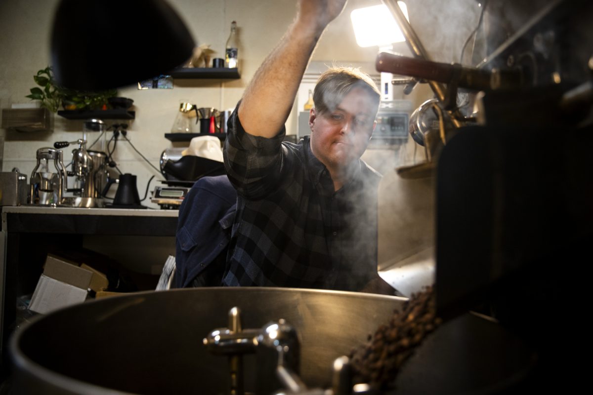 Brass Ring Coffee owner and operator Sam Caster dumps beans out of the roaster at his roastery in his backyard in Iowa City, Iowa, on Wednesday, Nov. 19, 2025. Caster supplies local coffee shops and residents with freshly roasted beans.