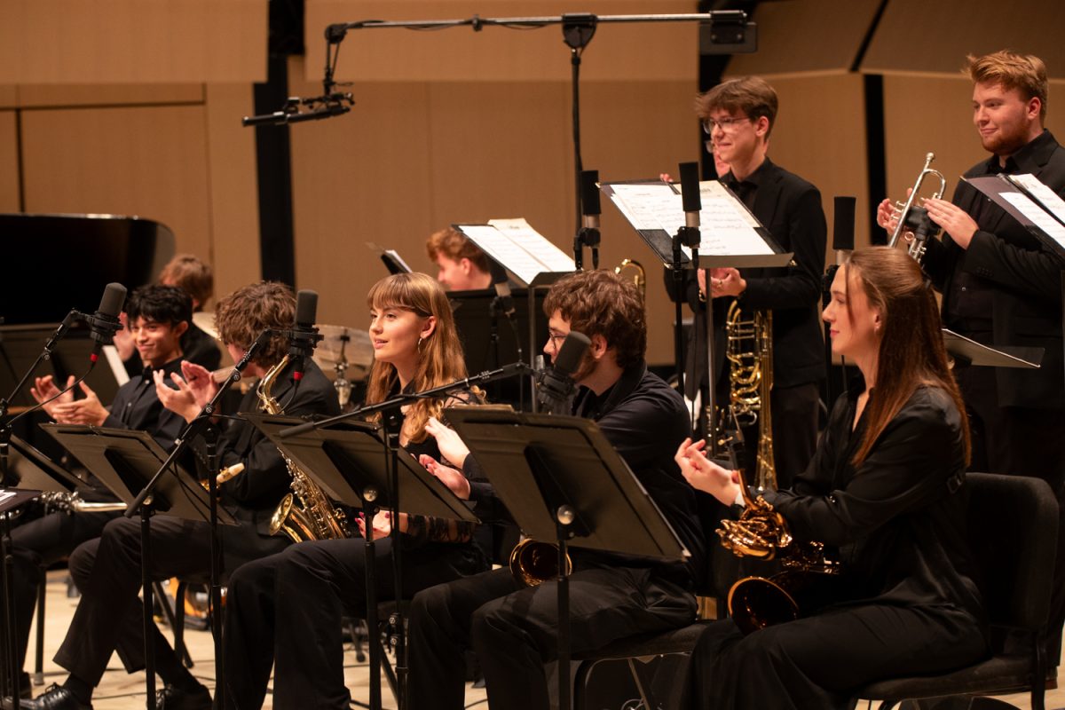 The University of Iowa ensemble applauds the conductor at the Jazz Repertory Ensemble Concert on Dec. 8, 2025 at the Voxman Music Building Concert Hall in Iowa City, Iowa.
