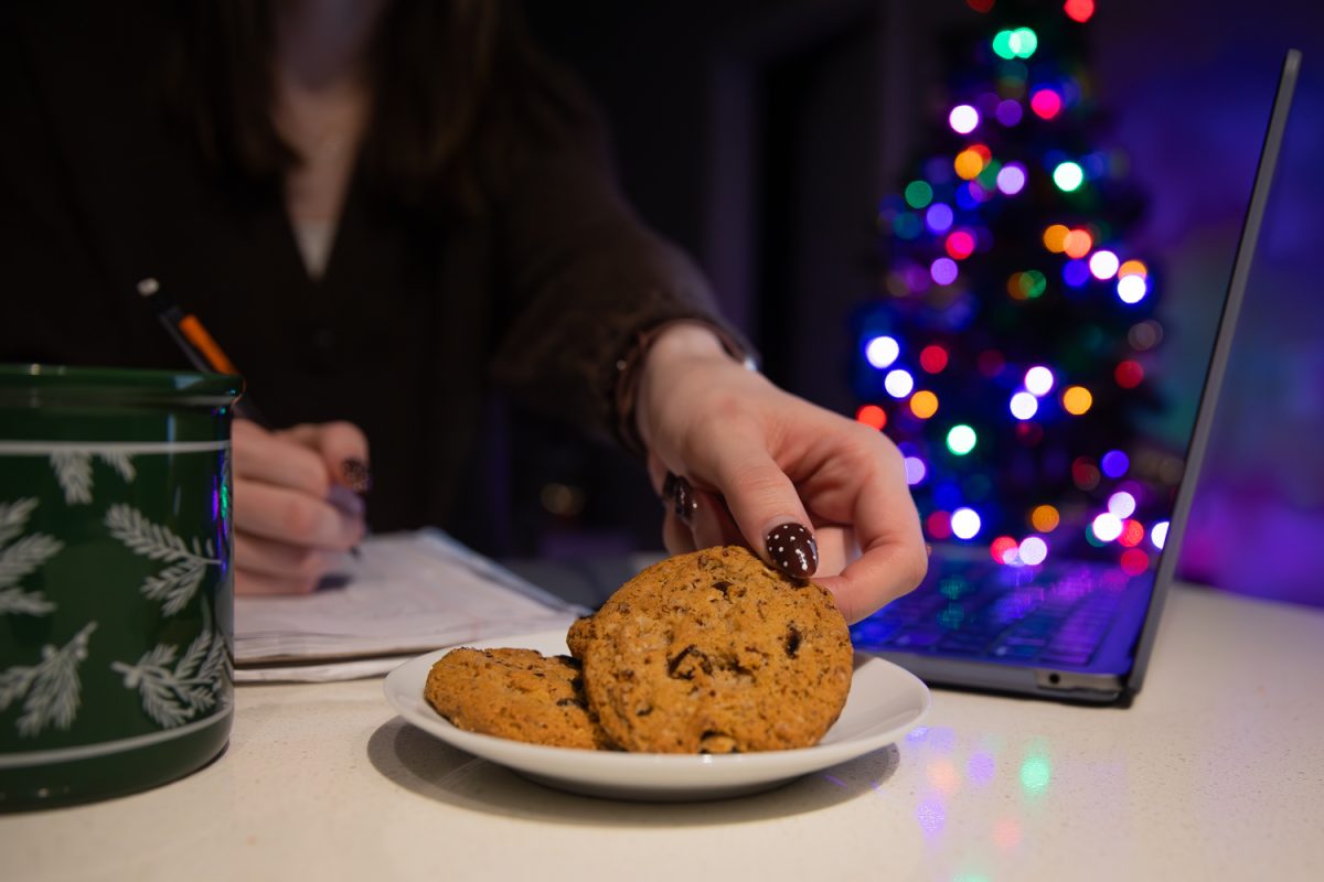 Student reaches for fresh baked cookie while studying for upcoming final exam in their apartment in Iowa City, Iowa on Wednesday, Dec. 10, 2025.
