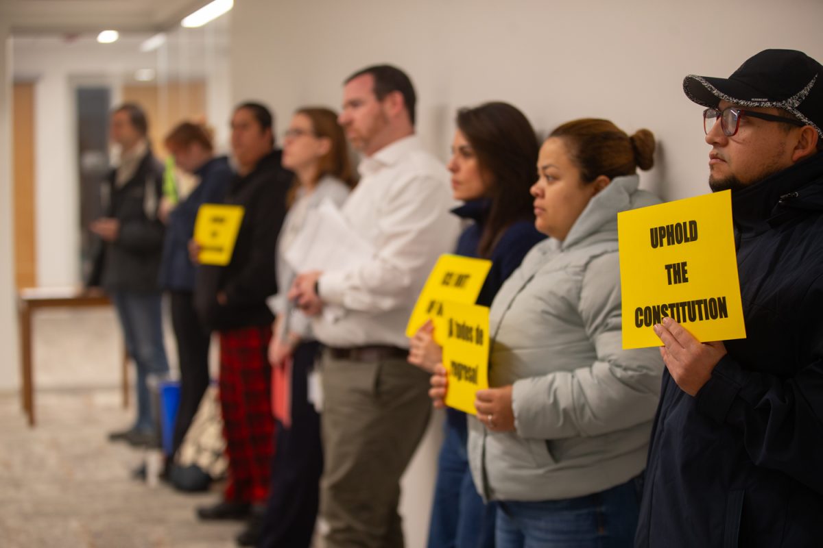 Activists protest ICE and their Fourth Amendment Rights during a formal meeting of the Johnson County Board of Supervisors inside the County Health and Human Services Building in Iowa City on Wednesday, Dec. 10, 2025.