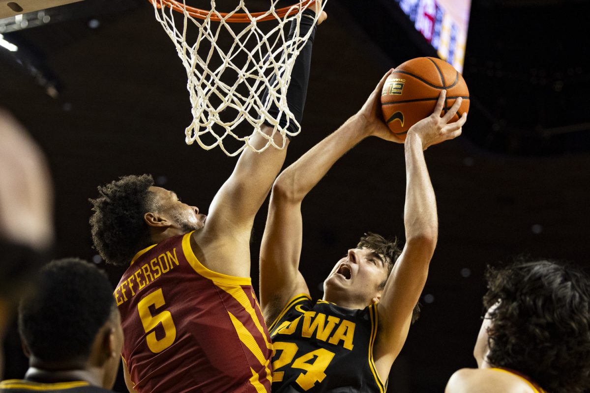 Iowa State forward Joshua Jefferson attempts to block a shot from Iowa guard Tate Sage during a men’s basketball game between the Iowa Hawkeyes and the Iowa State Cyclones at the Hilton Coliseum in Ames, Iowa on Thursday, Dec. 11, 2025. The Hawkeyes fell to the Cyclones 66-62. (Samantha DeFily/The Daily Iowan)