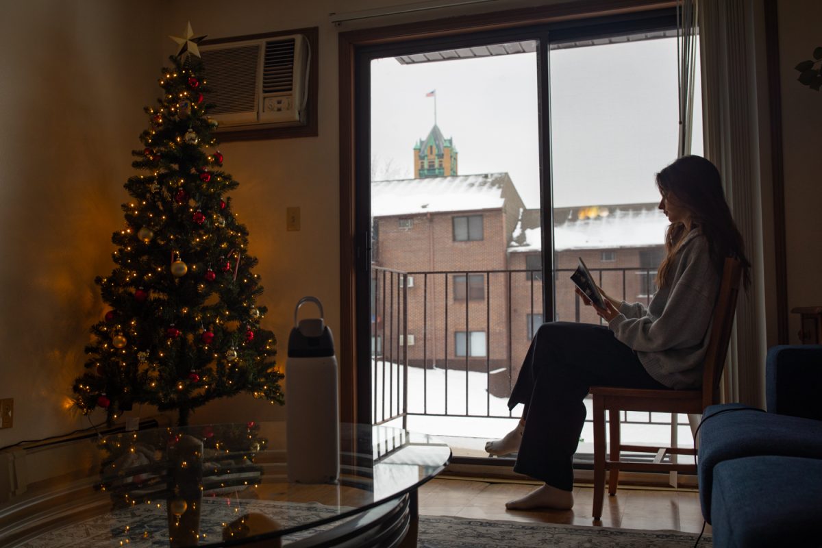 Hailey Shaffer reads a book in her living room in Iowa City on Friday, Dec. 12, 2025. Reading is one of multiple indoor holiday activities that Hailey engages in during the winter season.
