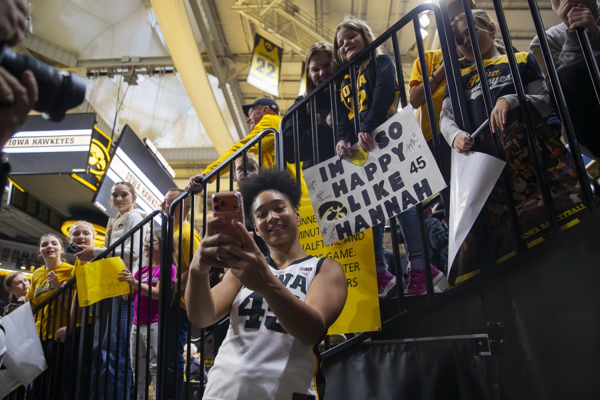 Iowa senior forward Hannah Stuelke takes a picture with a fan after a game between No.11 Iowa and Lindenwood at Carver-Hawkeye Arena on Saturday, Dec. 13, 2025. Stuelke had a 31 point game, this is the most points in a single game she has had this season. Stremlow had eight points with five assists. The Hawkeyes defeat the Lions 102-68 in dominant win.