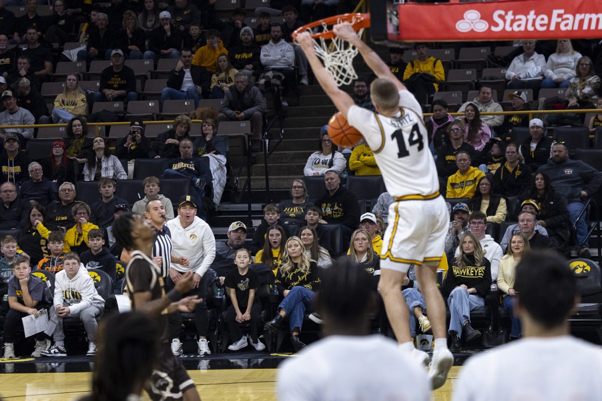Fans watch as Iowa guard Bennett Stirtz dunks the ball during a men’s basketball game between the Iowa Hawkeyes and Western Michigan Broncos at Carver-Hawkeye Arena on Sunday, Dec. 14, 2025. Stirtz had 13 points. The Hawkeyes defeated the Broncos 91-51. (Samantha DeFily/The Daily Iowan)