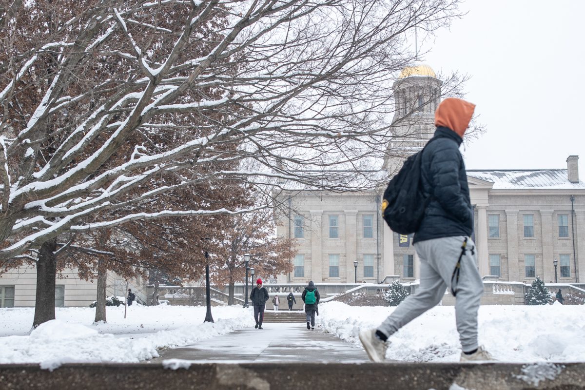 College students travel to their scheduled classes in Iowa City on Monday, Dec. 1, 2025. Students at the University of Iowa adapted to the sudden shift to winter weather upon returning to campus from Thanksgiving Break. Iowa City experienced a 10.5 inch snow fall on Saturday, Nov. 29, 2025.