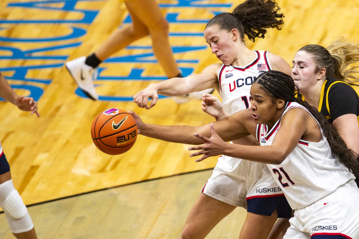 Iowa center Layla Hays attempts to gain possession of the ball from UConn forward Sarah Strong during a basketball game between the Iowa Hawkeyes and the UConn Huskies at the Barclays Center in Brooklyn, NY on Saturday, Dec. 20, 2025. The Huskies defeated the Hawkeyes 90-64. (Emma Calabro/The Daily Iowan)