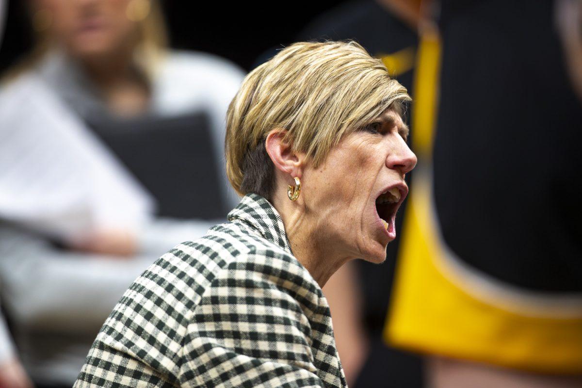 Iowa head coach Jan Jensen speaks to the team during a timeout at a basketball game between the Iowa Hawkeyes and the UConn Huskies at the Barclays Center in Brooklyn, NY on Saturday, Dec. 20, 2025. The Huskies defeated the Hawkeyes 90-64. (Emma Calabro/The Daily Iowan)