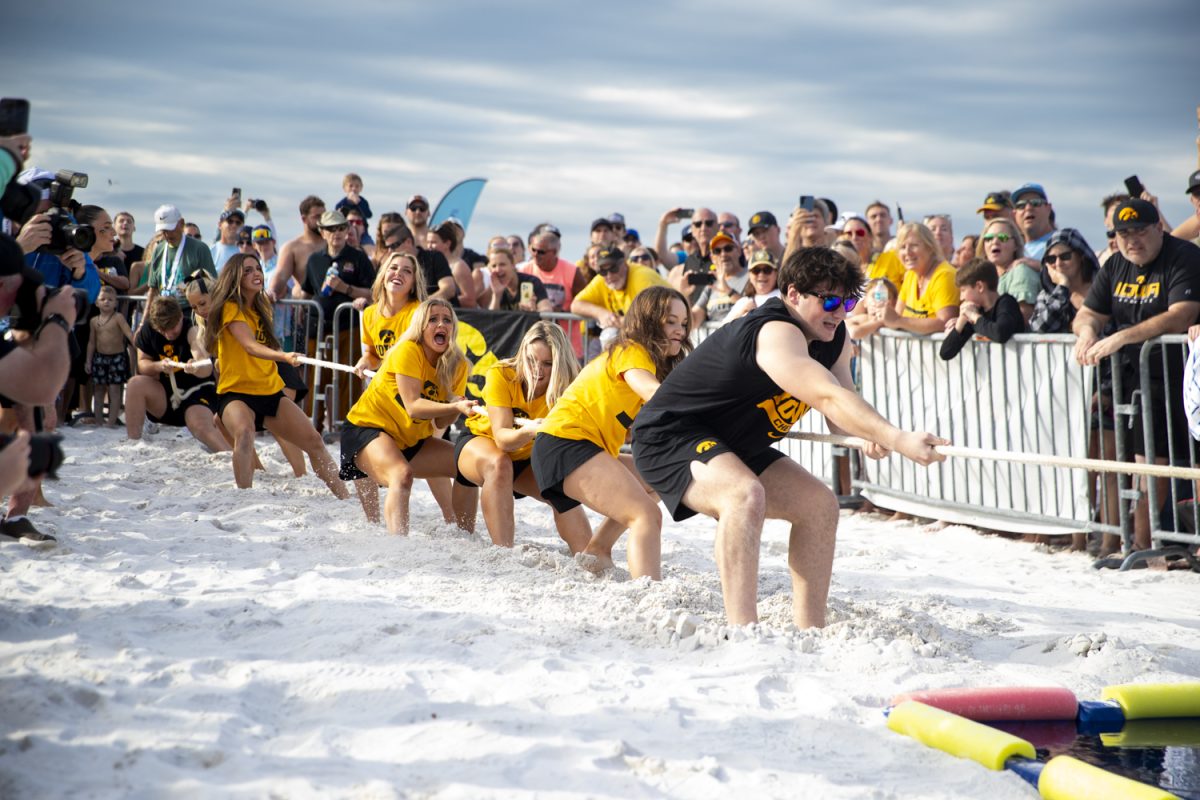 Iowa Spirit Squad members compete in tug of war against Vanderbilt’s Spirit Squad during a Beach Day hosted by the ReliaQuest Bowl at the Hilton Clearwater Beach on Monday, Dec. 29, 2025. This event featured competitions between opposing fans, spirit squads, and marching bands. (Samantha DeFily/The Daily Iowan)