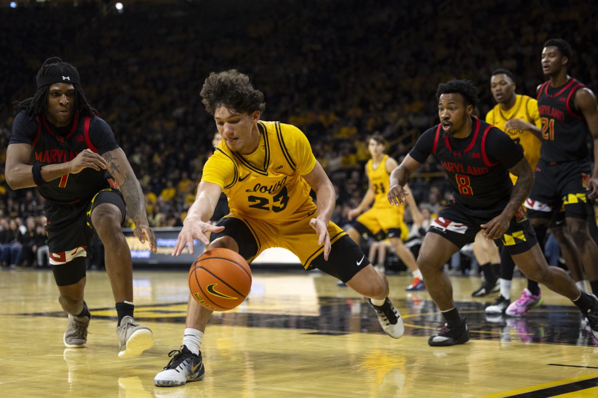 Iowa guard Isaia Howard lunges for the ball during a basketball game between the Iowa Hawkeyes and the Maryland Terrapins at Carver-Hawkeye Arena on Saturday, Dec. 6, 2025. The Hawkeyes defeated the Terrapins 83-64.