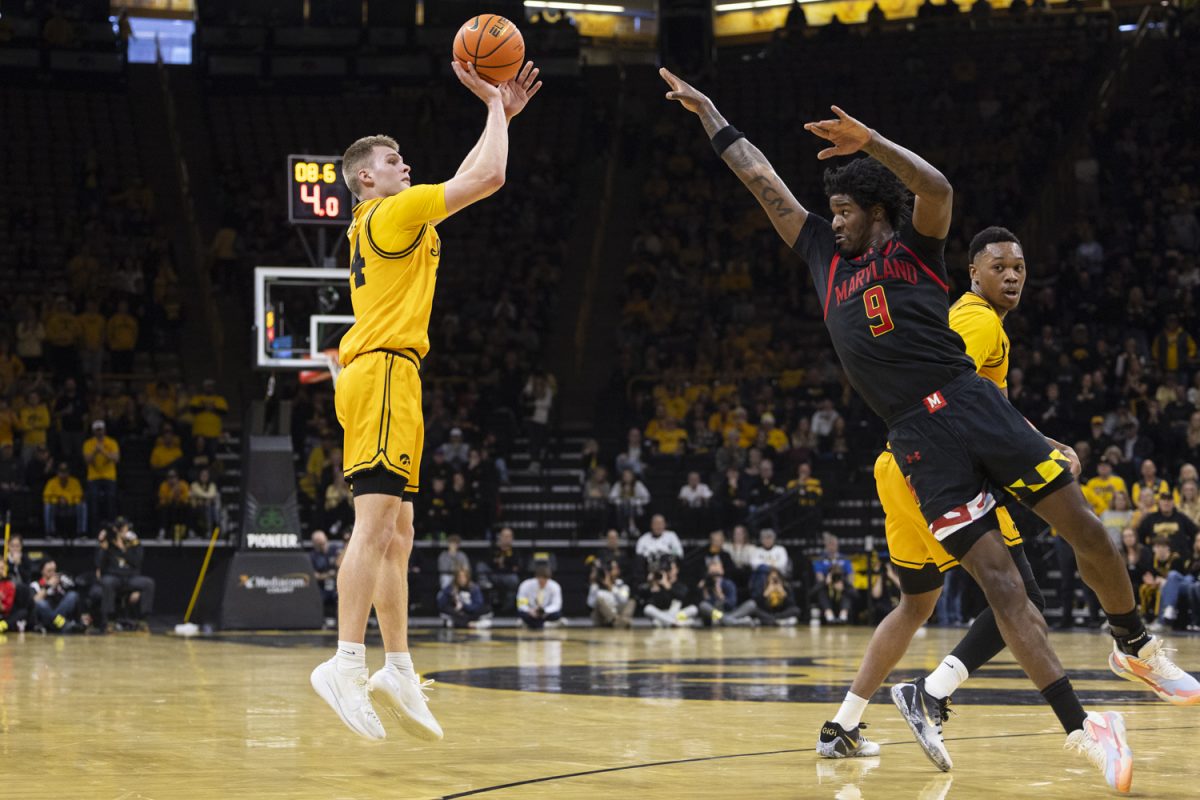 Maryland forward Solomon Washington attempts to block a shot from Iowa guard Bennett Stirtz during a basketball game between the Iowa Hawkeyes and the Maryland Terrapins at Carver-Hawkeye Arena on Saturday, Dec. 6, 2025. The Hawkeyes defeated the Terrapins 83-64.