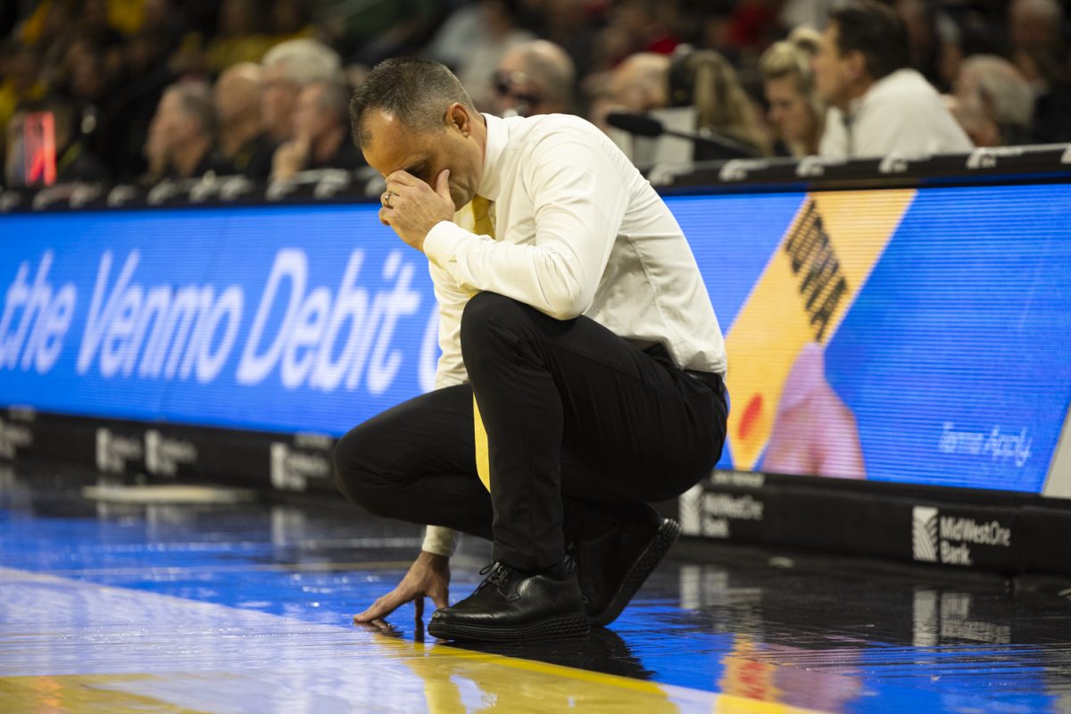 Iowa head coach Ben McCollum rests his head on his hand during a basketball game between the Iowa Hawkeyes and the Maryland Terrapins at Carver-Hawkeye Arena on Saturday, Dec. 6, 2025. The Hawkeyes defeated the Terrapins 83-64.