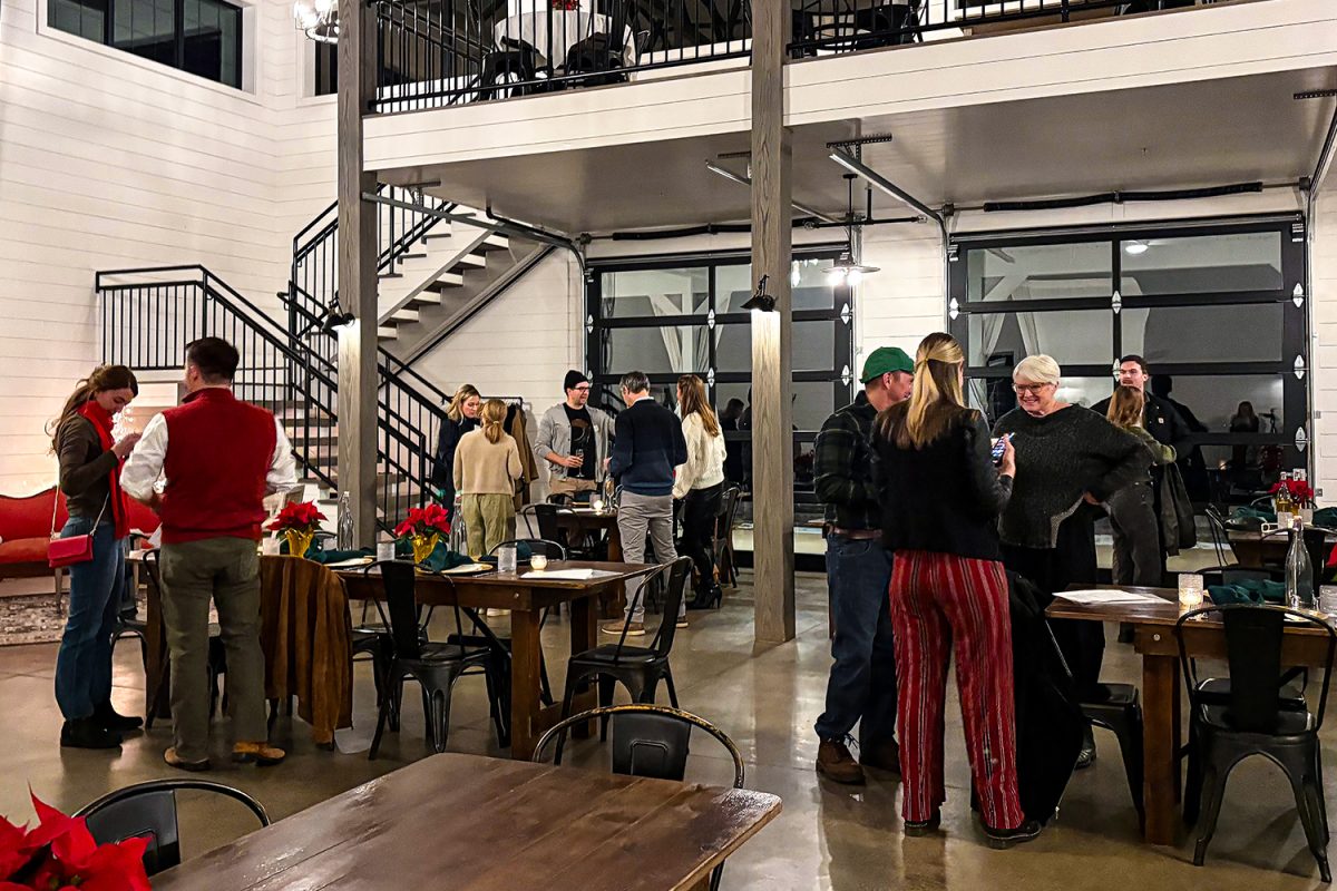 Guests mingle around the tables at the Walker Homestead in Iowa City, gathering information that can help them solve a murder case on Friday, Dec. 5, 2025. "A Very Vineyard Christmas Murder Mystery Dinner" was held at the Homestead, treating people to a night of secrets and sleuthing. 