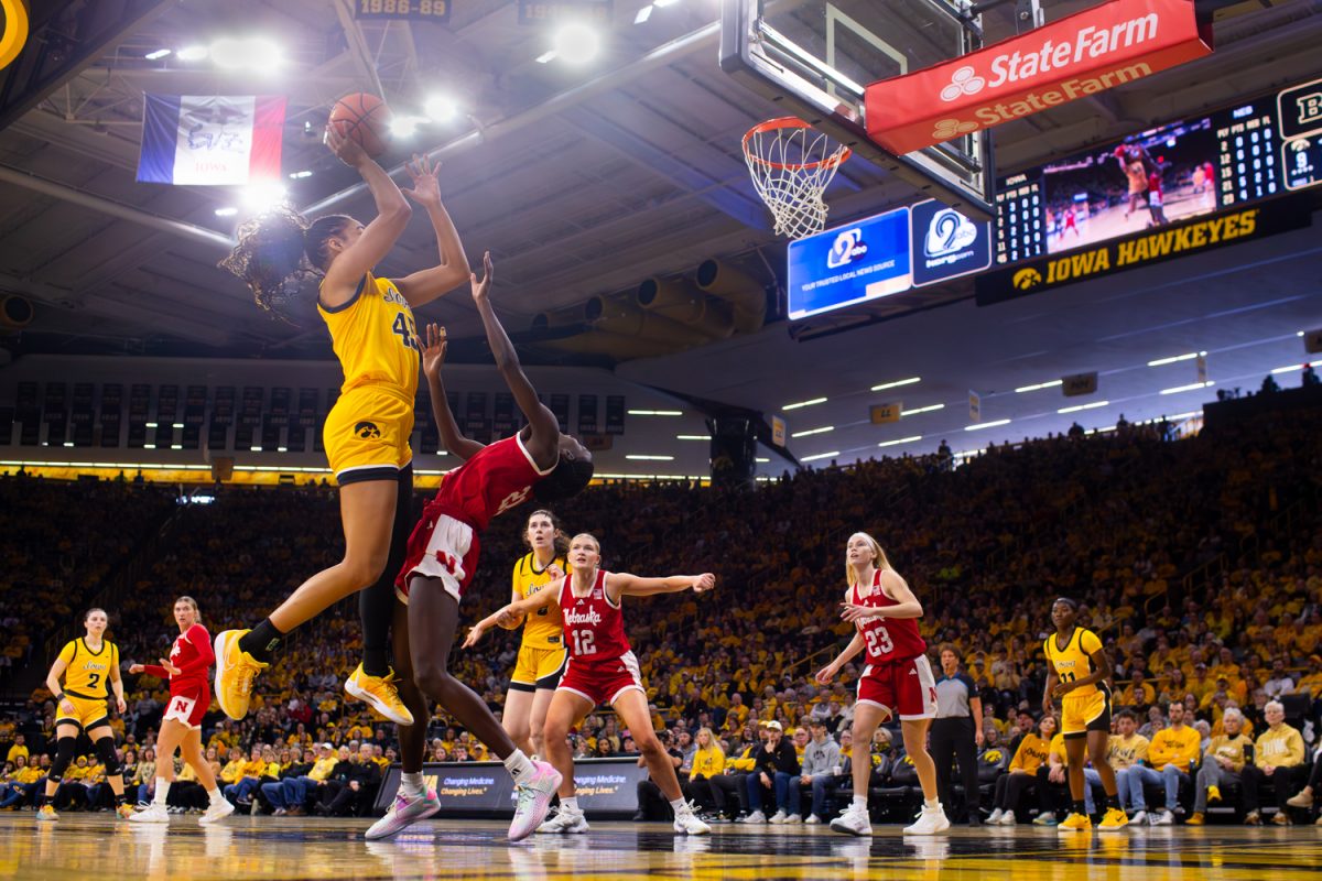 Iowa senior forward Hannah Stuelke attempts to shoot in the basketball game between the No. 14 Iowa Hawkeyes and No. 20 Nebraska Cornhuskers at Carver-Hawkeye Arena on Thursday, Jan. 1, 2025. Stuelke put up a double-double, with 21 points and 10 rebounds, coming into shape as Iowa’s most dominant player. The Hawkeyes defeat the Cornhuskers 86-76 in thrilling close match.