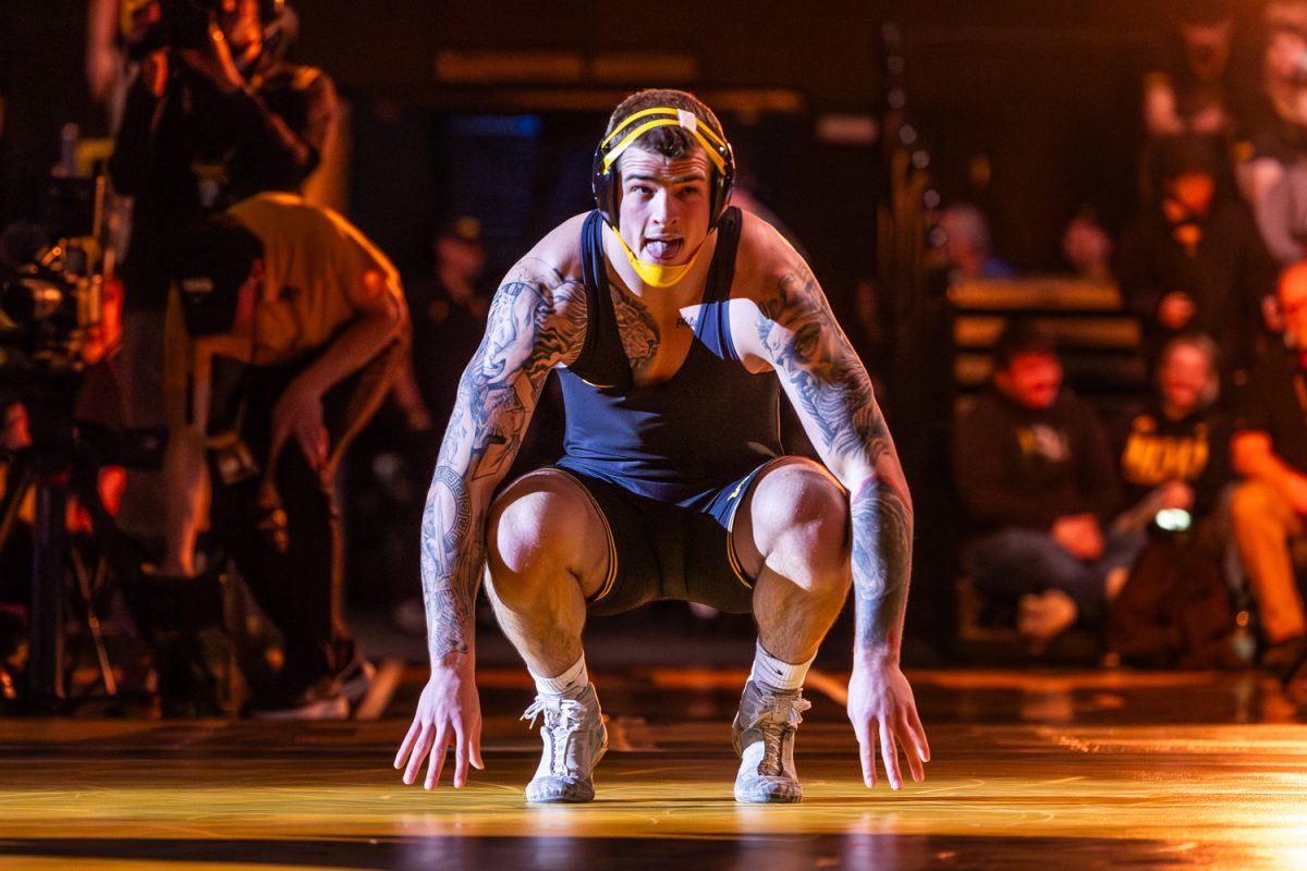 Iowa 285 pounder, No. 5 Ben Kueter, sticks out tongue to Wisconsin opponent, No. 9 Braxton Amos, during a dual between the No. 4 Iowa Hawkeyes and the No. 18 Wisconsin Badgers at Carver-Hawkeye Arena in Iowa City, Iowa, on Friday, Jan. 9, 2026. Kueter defeated Amos in a 4-1 sudden victory. The Hawkeyes defeated the Badgers 23-12.