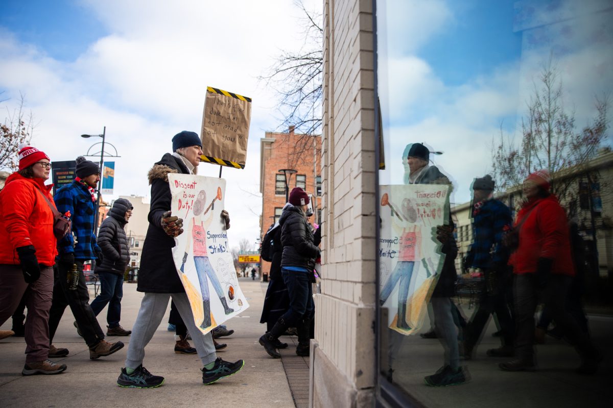 Protesters silently walk at an ‘ICE Out For Good’ rally in downtown Iowa City on Sunday, Jan. 11, 2025. Following the death of Renee Good in Minneapolis, who was shot by a U.S. Immigration and Customs Enforcement (ICE) officer last week, protesters in Iowa City chanted her name, sung songs, and marched silently to the Ped Mall. Around 1,500 protesters attended, with a candle light vigil planned for 6:30 p.m.
