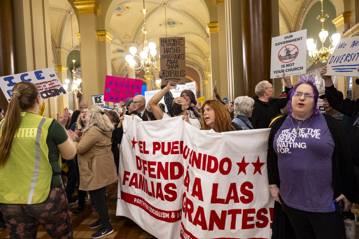 Protesters yell out and hold up signs during the second day of the 2026 Iowa legislative session at the Iowa State Capitol in Des Moines on Tuesday, Jan. 13, 2026. (Samantha DeFily/The Daily Iowan)