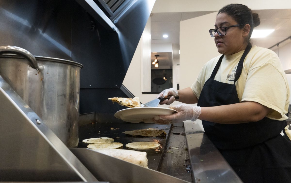 Isabel Luna plates food at the new downtown restaurant in Iowa City on Jan. 24. Luna’s Tacos offers a variety of Mexican food, including burritos, quesadillas, and more.