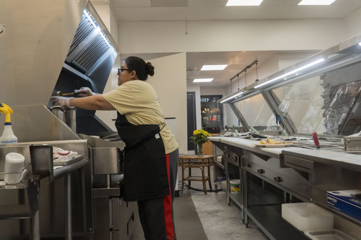 Isabel Luna pours sauce at the new downtown restaurant in Iowa City on Jan. 24. Luna’s Tacos offers a variety of Mexican food, including burritos, quesadillas, and more.