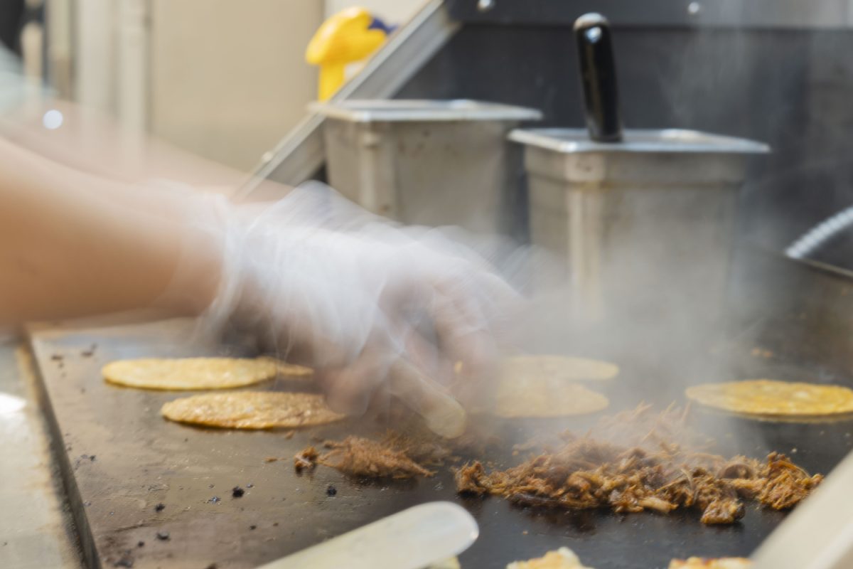 Isobel Luna cooks meat at the new downtown restaurant in Iowa City on Jan. 24. Luna’s Tacos offers a variety of Mexican food, including burritos, quesadillas, and more.