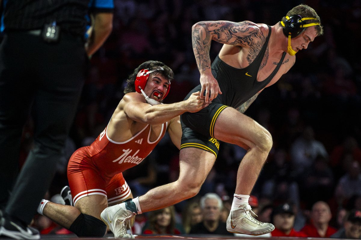 Nebraska No. 4 285-pounder AJ Ferrari attempts to hold on as Iowa’s No. 8 Ben Kueter escapes during a duel between the No. 4 Iowa Hawkeyes and the No. 6 Nebraska Cornhuskers at Devaney Sports Center in Lincoln, Nebraska on Friday, Jan. 23, 2026. Ferrari defeated Kueter 4-1. The Hawkeyes defeated the Cornhuskers 22-14.(Reece Schrader/Daily Iowan)