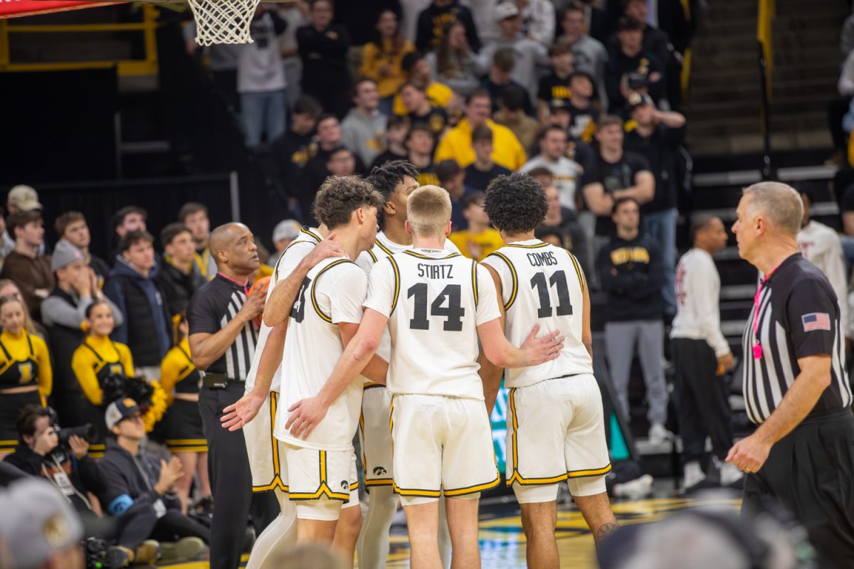 Iowa team huddles during a basketball game between the Iowa Hawkeyes and the Southern California Trojans at Carver-Hawkeye Arena on Wednesday, Jan. 28, 2026. The Hawkeyes defeated the Trojans, 73-72. (Patrick Murphy / The Daily Iowan).