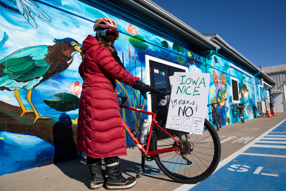 Angie Smith sets up her bike before a bike ride on Saturday, Jan. 31, 2026, in solidarity with Alex Pretti, an ICU nurse and bicyclist who was shot and killed by ICE on Jan. 24. The ride was organized by the Bicycle Fun Club and began at the Bike Library before continuing around Iowa City. Riders chanted and held protest signs. (Ava Neumaier / The Daily Iowan)