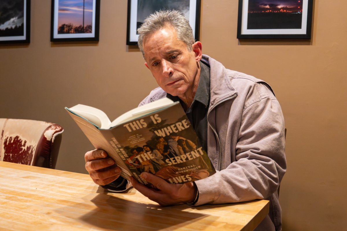 Daniyal Mueenuddin poses with his book at Prairie Lights Cafe in Iowa City, Iowa on Thursday, Jan. 25th, 2026. He is on tour and made a stop at Prairie Lights to talk about his book with Hurmat Kazmi. (Andy Espineira/The Daily Iowan)