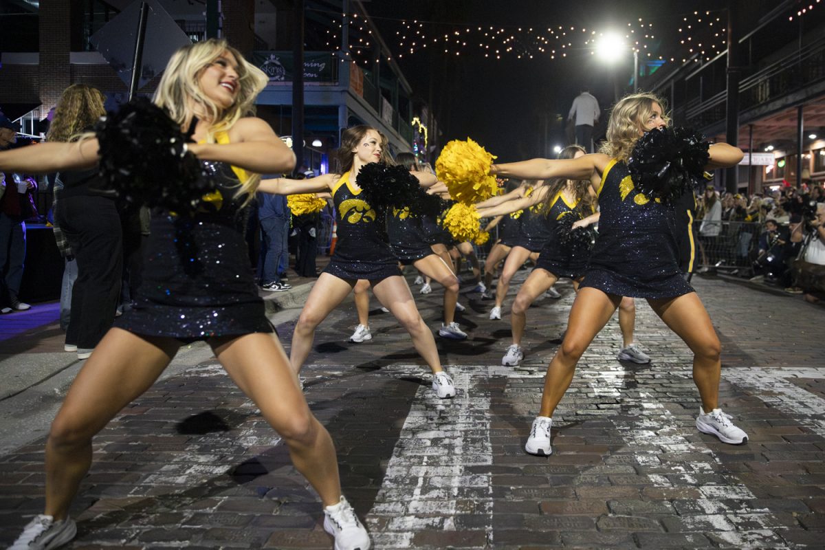 The Iowa Spirit Squad performs during the battle of the bands between Iowa’s Hawkeye Marching Band and Vanderbilt’s Spirit of Gold Marching Band on Tuesday, Dec. 30, 2025 in Ybor City in Tampa, Florida. The matchup between the Iowa Hawkeyes and the Vanderbilt Commodores is on Wednesday, Dec. 31 at Raymond James Stadium. (Samantha DeFily/The Daily Iowan)