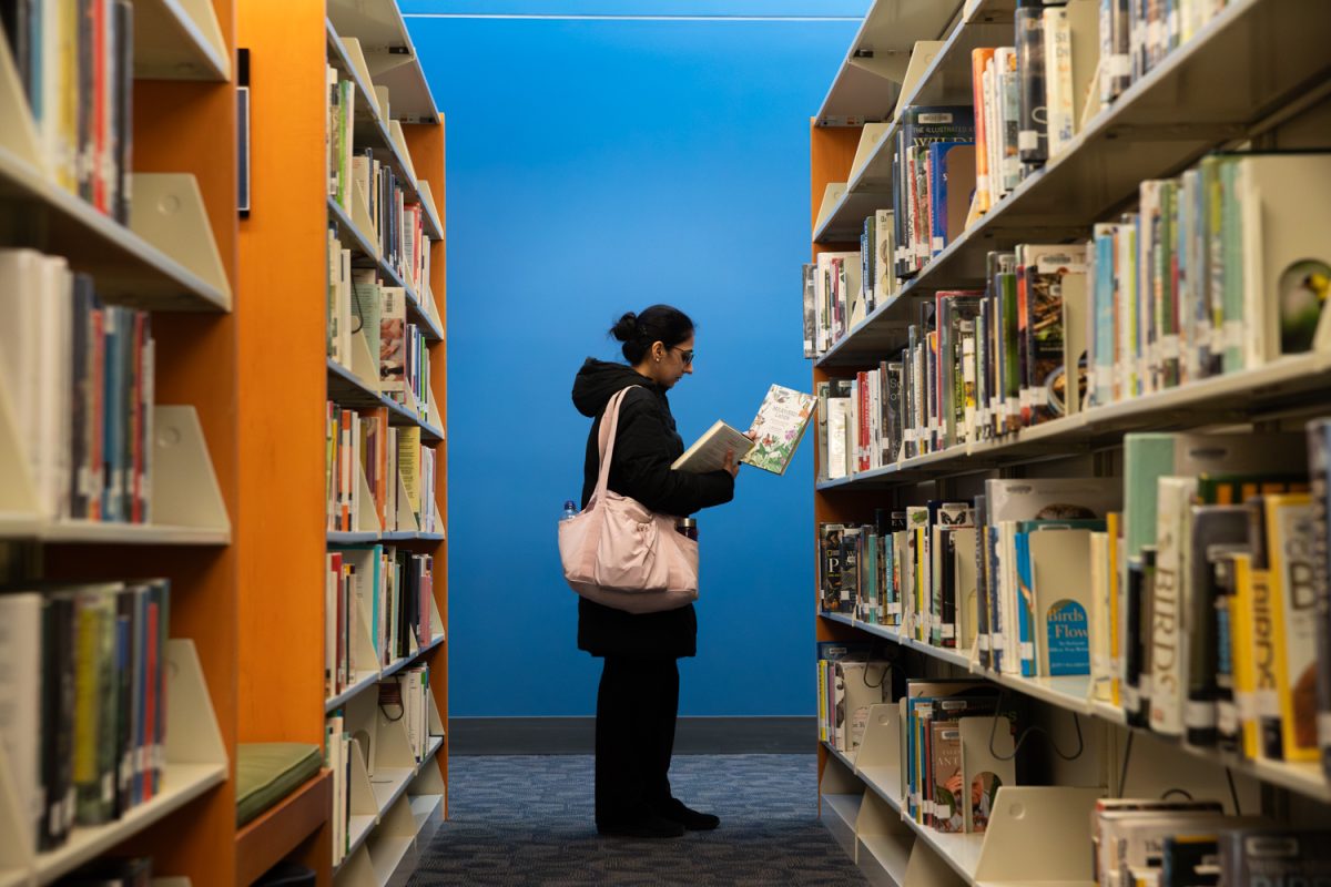 Library patron Arsala is seen browsing the books on the second floor stacks of the Iowa City Public Library in Downtown Iowa City on Thursday, Jan. 29, 2026. (Ethan McLaughlin/The Daily Iowan)