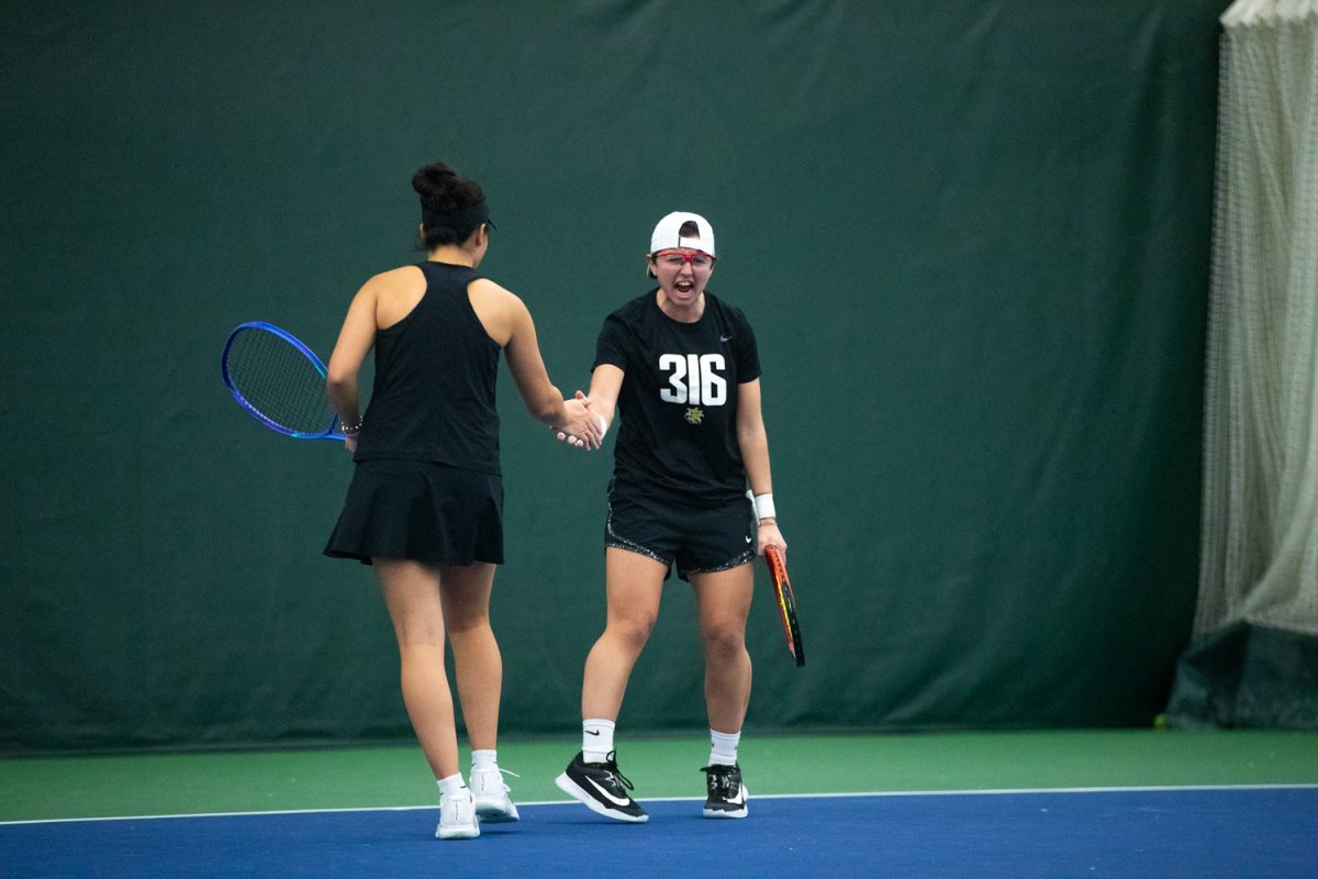 Wichita State junior Giorgia Roselli celebrates with her doubles teammate junior Xin Tong Wang in a tennis match between Iowa and Wichita State in the Hawkeye Tennis and Recreational Complex on Sunday, Feb. 1, 2026. The Hawkeyes lost 2-4 to the Shockers, making this their third loss in a row. (Travis Crabb/The Daily Iowan)