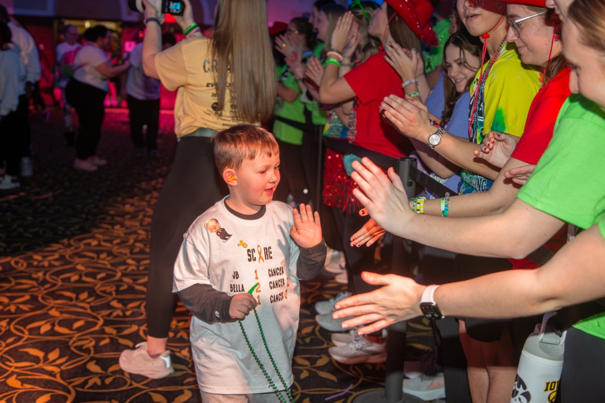 A kid high-fives the crowd during the University of Iowa’s 32nd Dance Marathon at the Iowa Memorial Union in Iowa City on Friday, Feb. 6, 2026. Over 1,000 dancers participated in this year’s Big Event, and the program has raised nearly $40 million through the last 32 years. (Andy Espineira/The Daily Iowan)