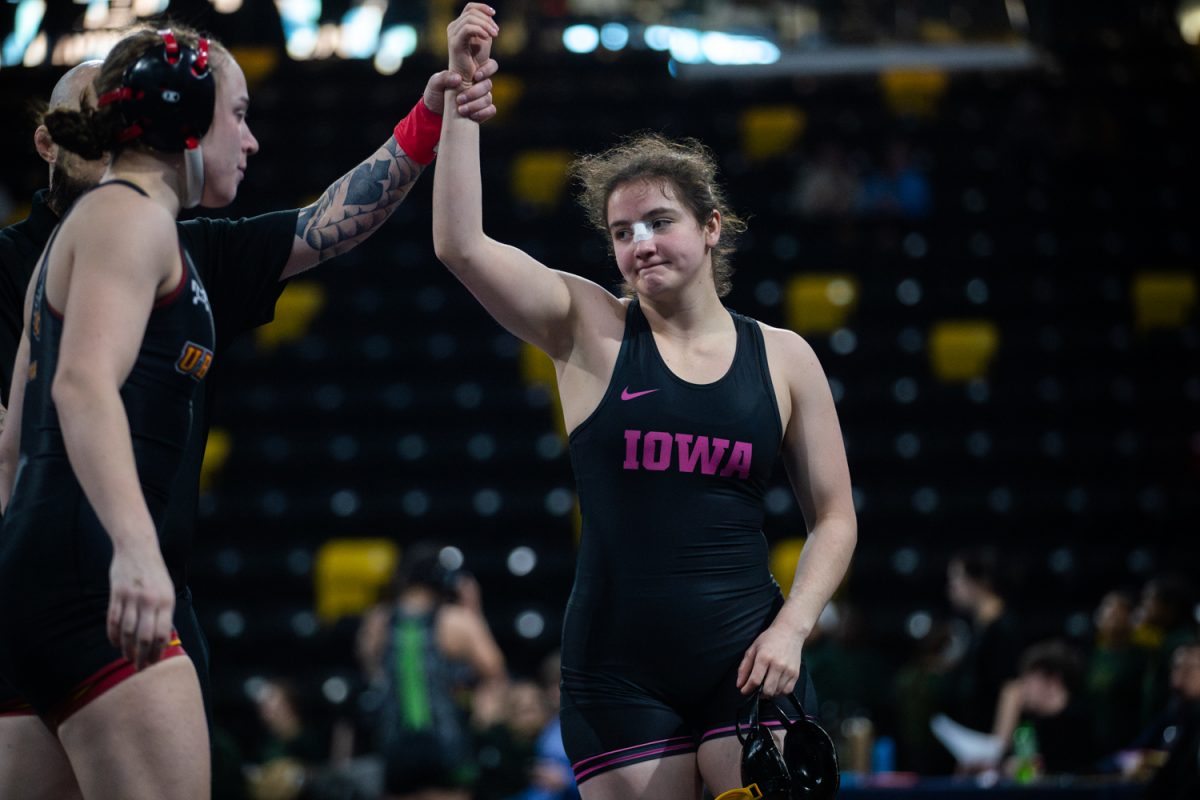 Iowa 131 pounder Bella Williams raises hand in victory after defeating Ursinus’s Paisley Fox during the collegiate “For Her” Dual Tournament at Xtreme Arena in Coralville, Iowa on Sunday, Feb. 8, 2026. Williams defeated Fox by technical fall. The No. 1 Hawkeyes defeated the Ursinus Grizzly Bears 32-13. (Reece Schrader/Daily Iowan)