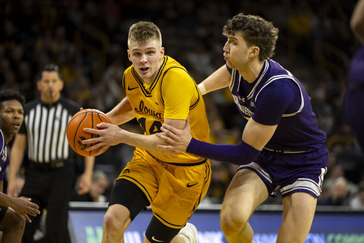 Iowa guard Bennett Stirtz attempts to get past Northwestern forward Nick Martinelli during a basketball game between the Iowa Hawkeyes and the Northwestern Wildcats at Carver-Hawkeye Arena on Sunday, Feb. 8, 2026. The Hawkeyes defeated the Wildcats 76-70. (Samantha DeFily/The Daily Iowan)