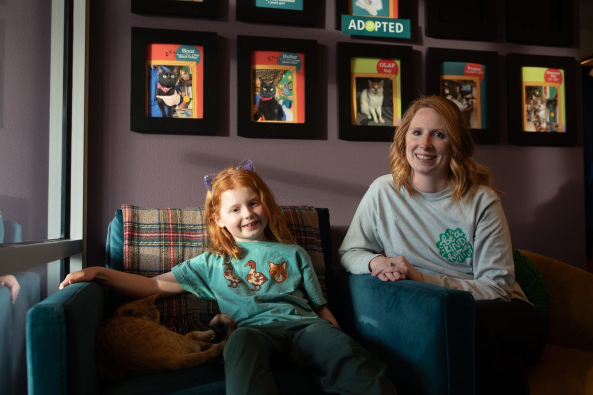 A family that adopted from Kitty Corner poses for a portrait at Kitty Corner in Iowa City, Iowa, on Tuesday, Feb. 10, 2026. (Sal Yang/The Daily Iowan)