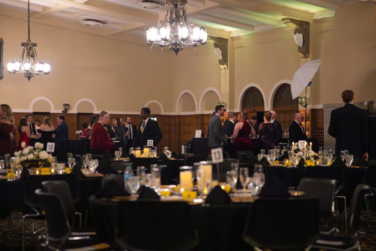 People mingle in ballroom for the IMU Centennial Gala in the Iowa Memorial Union building in Iowa City on Saturday, Feb. 14, 2026. This gala is held to celebrate the 100 years of history, and look into the future of the IMU. (Travis Crabb / The Daily Iowan)