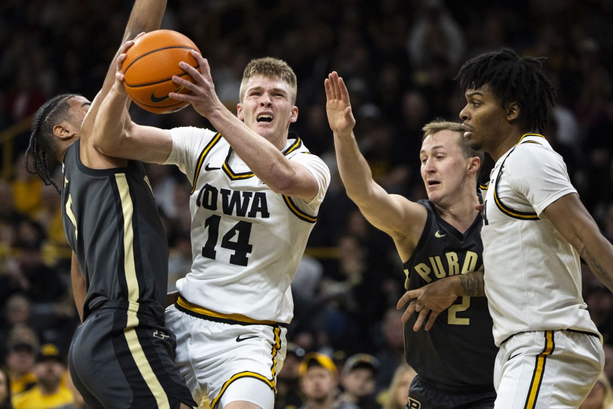 Iowa guard Bennett Stirtz attempts to get past the Purdue defense during a basketball game between the Iowa Hawkeyes and the No. 13 Purdue Boilermakers at Carver-Hawkeye Arena on Saturday, Feb. 14, 2026. The Boilermakers defeated the Hawkeyes, 78-57. (Samantha DeFily/The Daily Iowan)