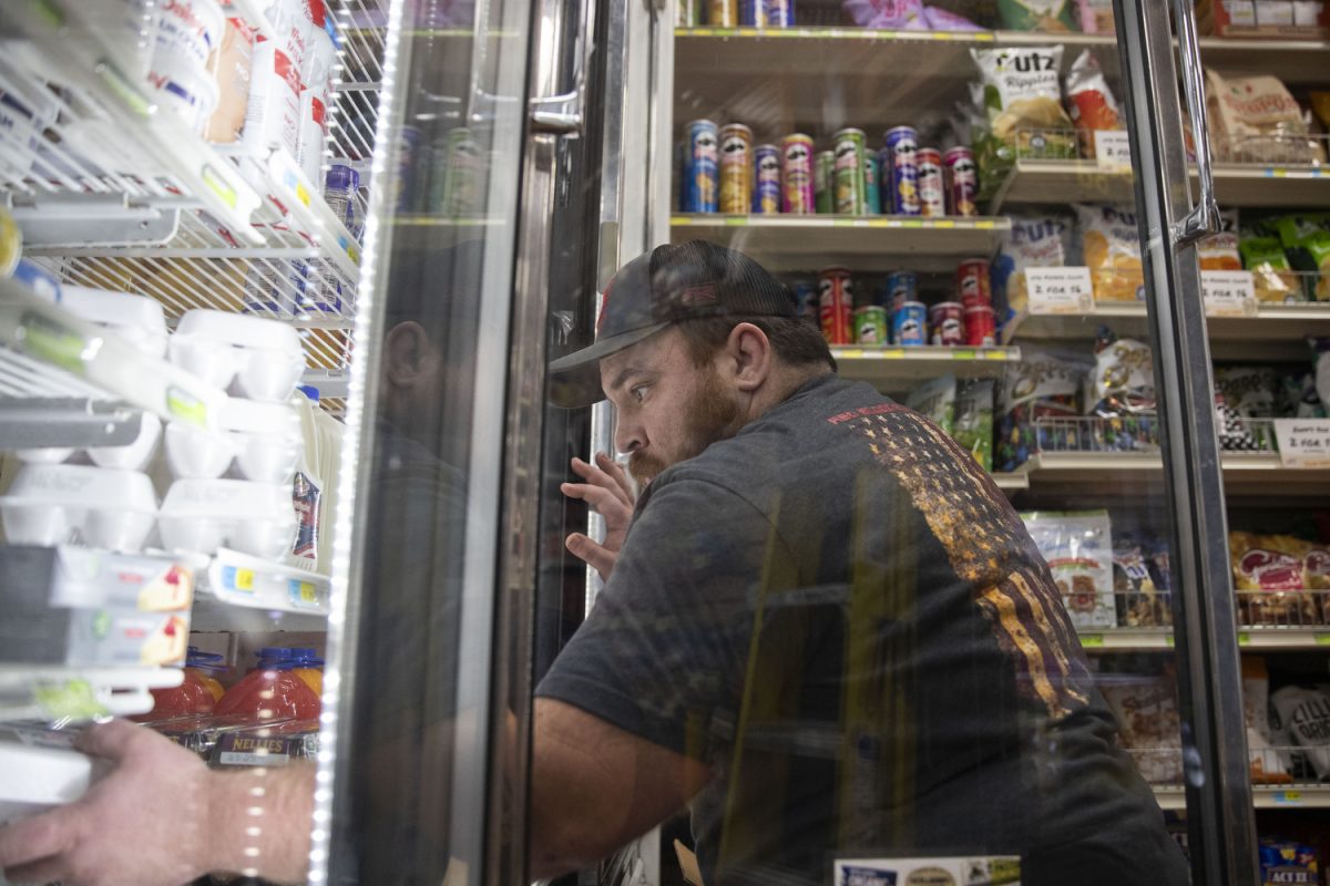Kyle, an employee at John’s Grocery in Iowa City on Feb. 15, 2026.  John’s and other small grocers have felt an impact and noticed confusion following SNAP changes in 2026.