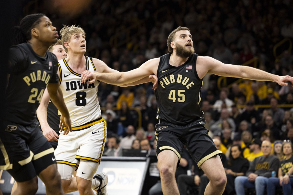 Purdue center Oscar Cluff boxes out Iowa forward Cooper Koch during a basketball game between the Iowa Hawkeyes and the No. 13 Purdue Boilermakers at Carver-Hawkeye Arena on Saturday, Feb. 14, 2026. The Boilermakers defeated the Hawkeyes, 78-57. (Samantha DeFily/The Daily Iowan)