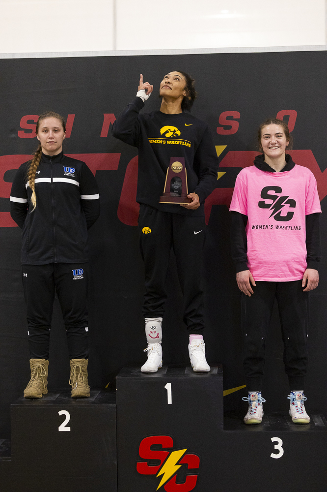 Iowa 160 pounder Kennedy Blades celebrates her win on the podium for her 1st place match on the second day of NCAA Regionals in the Cowles Field House at Simpson College in Indianola on Saturday, Feb. 21, 2026. Blades won all her matches by technical fall with a score of 10-0, she gave up no points this tournament. The Iowa Hawkeyes won the tournament taking home first in eight of the ten weight classes, with second place in the others. (Travis Crabb/The Daily Iowan)